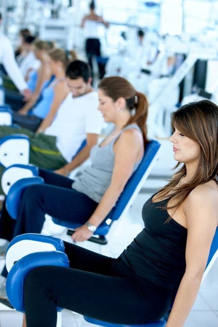 Group of people exercising with the machines at the gym