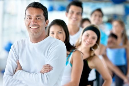 Portrait of a group of people at the gym smiling