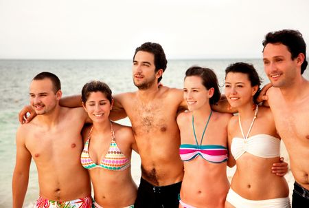 Happy group of friends at the beach