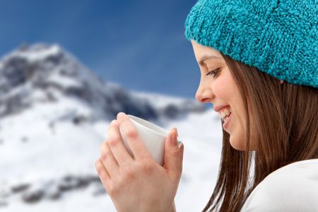 Happy winter woman with a hot drink