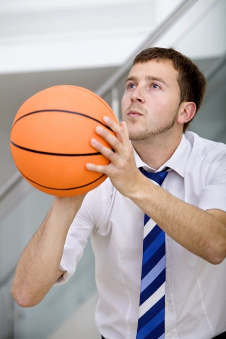 Handsome business man ready to throw a basketball