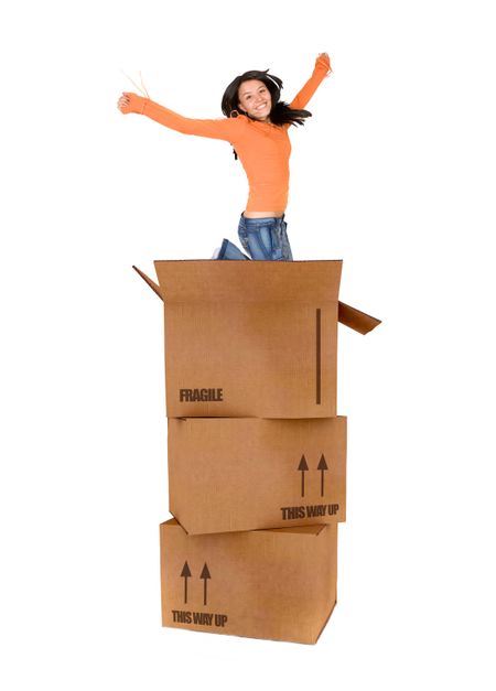 Casual woman jumping with cardboard boxes isolated