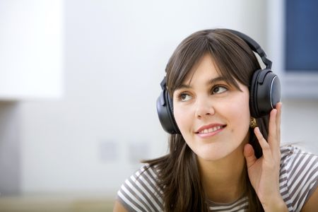 Young woman portrait with headphones smiling indoors