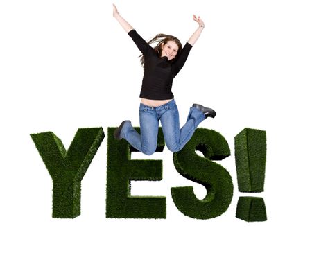 Excited woman jumping with word 'yes' behind isolated