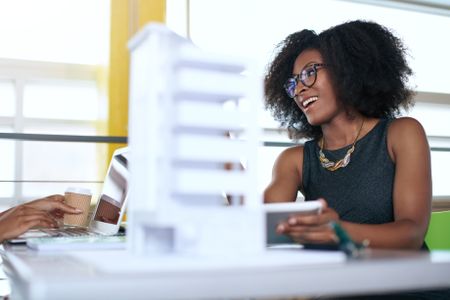 Two  colleages discussing ideas using a tablet computer