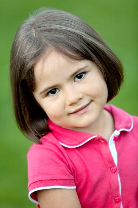Portrait of a beautiful little girl smiling outdoors