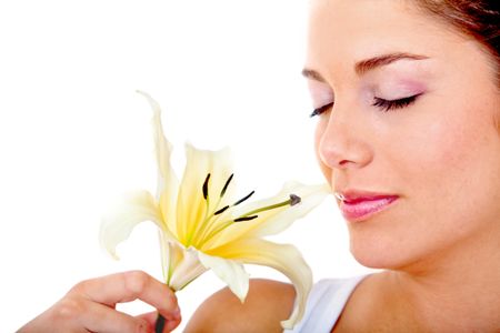 Beautiful woman portrait smelling a flower isolated
