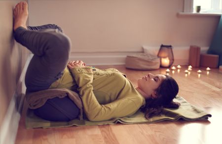 Attractive mixed race woman doing restorative yoga