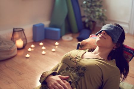 Attractive mixed race woman doing restorative yoga