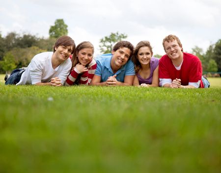 Group of friends lying on grass outdoors