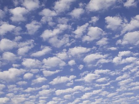 Multitude of fluffy white clouds in blue sky