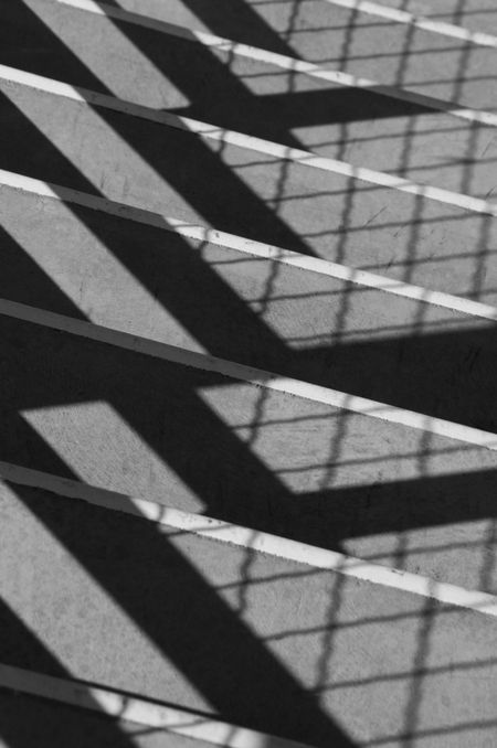 Symmetrical shadows cast by sunlight on indoor college stairway