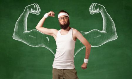 A young male with beard and glasses posing in front of green background, imagining how he would look like with big muscles, illustrated by white drawing concept.