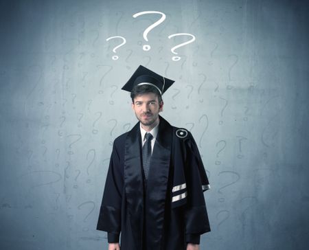 Young graduate teenager with question marks drawn over his head