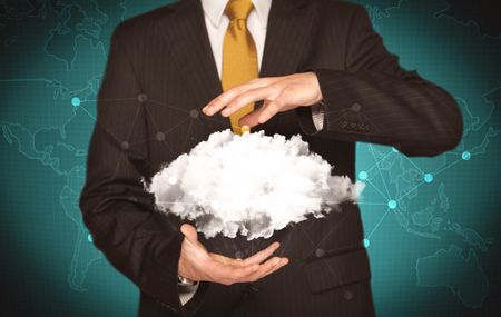 Elegant business person holding an empty white cloud in its hands in front of green wall background with world map illustration concept
