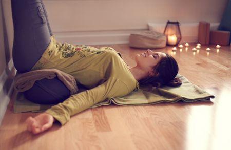 Attractive mixed race woman doing restorative yoga