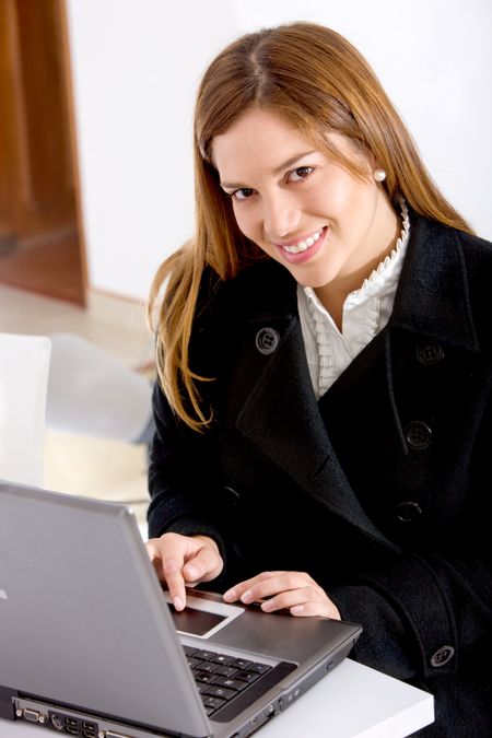 Business woman working on a laptop at her office