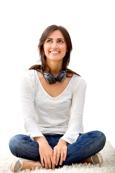 Woman sitting on the floor with headphones isolated