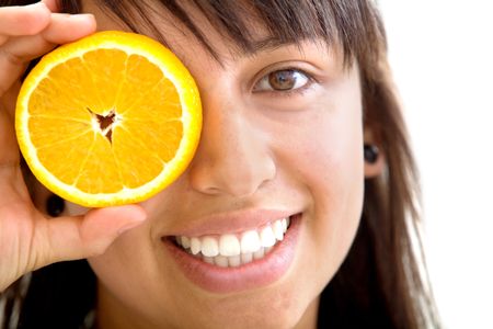 Woman with a slice of orange in her eye isolated