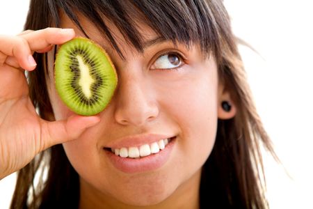 Woman with a slice of kiwi in her eye isolated