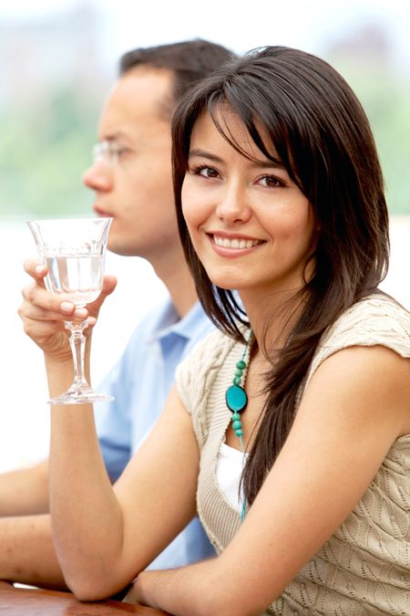 Beautiful woman with a glass of wine smiling