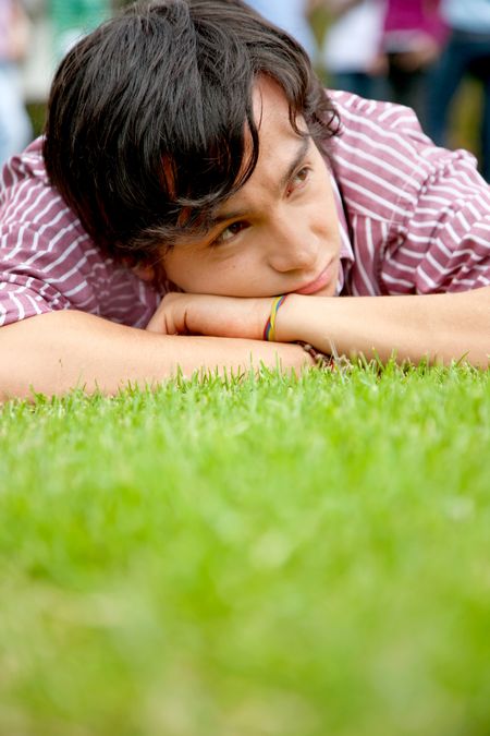 Nostalgic man portrait lying on grass outdoors