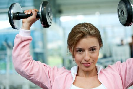 woman at the gym lifting free weights