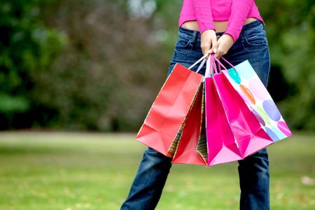 Unrecognizable woman holding some shopping bags outdoors