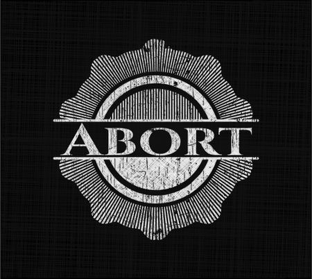 Abort chalkboard emblem written on a blackboard