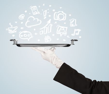 A professional waiter holding a silver plate with drawn communication, business and online media icons in front of a light blue background