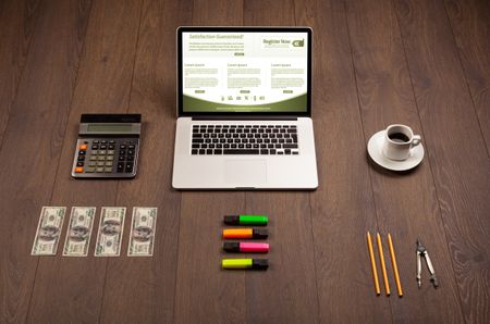 Business wooden table with notebook computer and office accessories