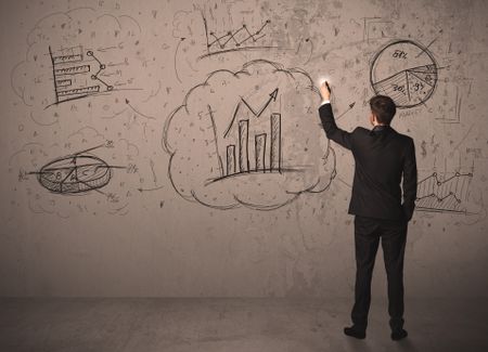 Businessman drawing a business project on a wall