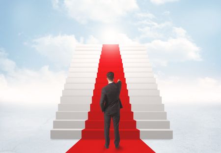 Businessman looking at stairs to heaven