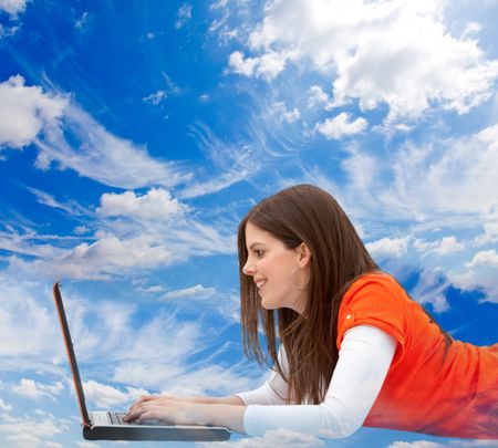 Woman lying on the floor with a computer