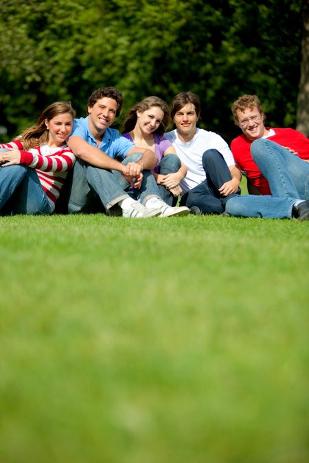 Casual group of friends sitting at the park