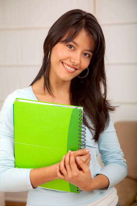 Portrait of a female student holding a notebook