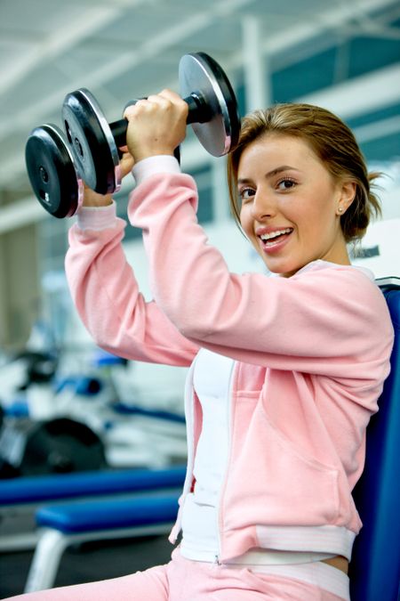 Woman exercising at the gym with free-weights