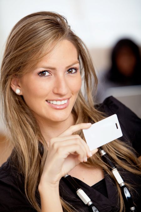 Business woman portrait holding a card and smiling