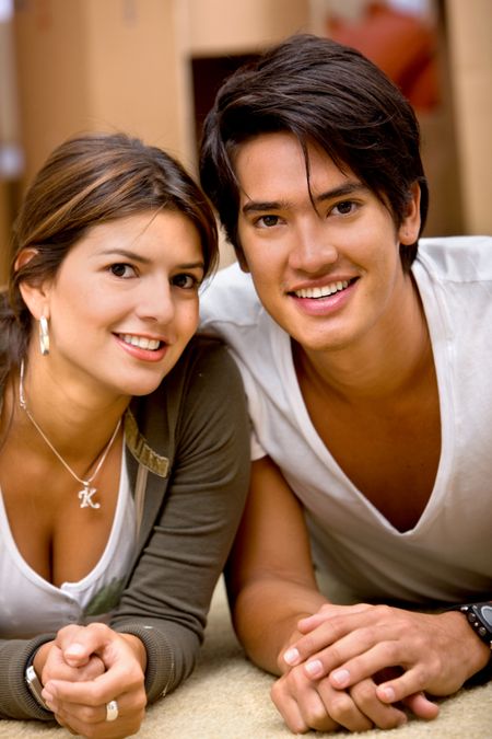 Portrait of a loving couple lying on the floor