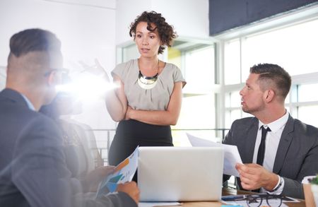 team of successful business people having a meeting in executive sunlit office