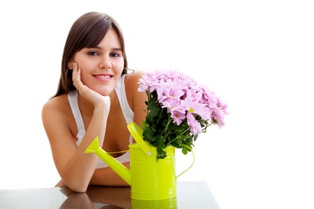 Girl with some flowers in a watering can isolated