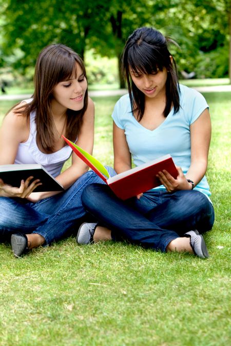 Casual girls portrait with notebooks studying outdoors