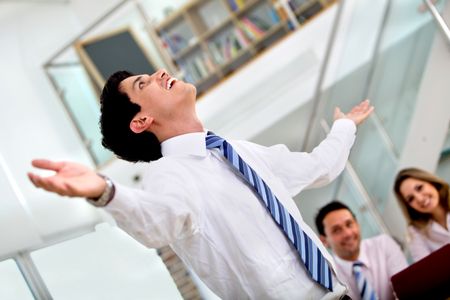 Happy business man with arms opened at an office