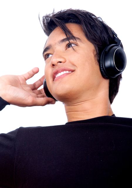 casual man listening to music in his headphones isolated over a white background