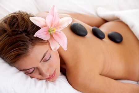 Woman with a flower on her head relaxing at a spa