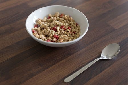 Breakfast cereal in a white bowl on a kitchen table