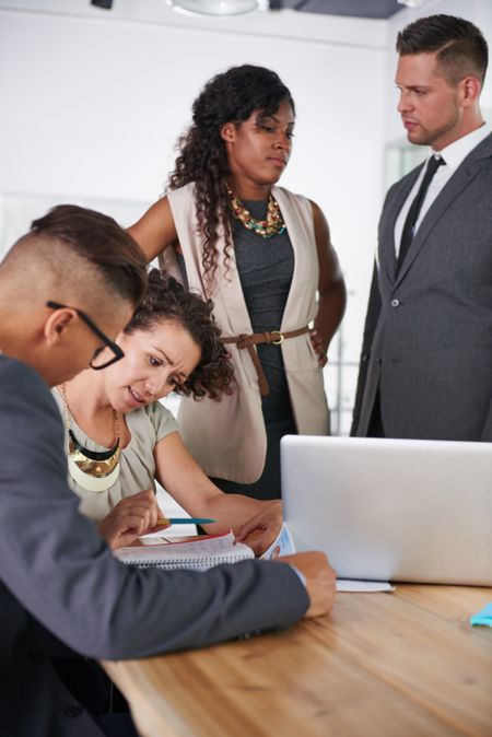 team of successful business people having a meeting in executive sunlit office