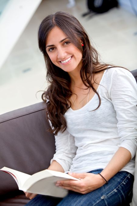 Beautiful woman portrait smiling and studying at home