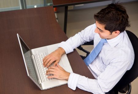 young business man on a laptop computer in an office