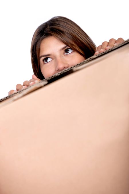 Girl appearing over a moving box isolated over a white background